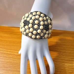 Cuff Bracelet metal silver base color engraved. With cream color acrylic stones